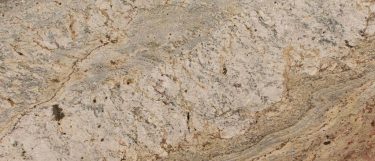 a typhoon bordeaux granite countertop surface that has a brown background with beige and gold veins