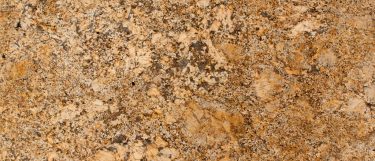 a solarius granite countertop surface that features dark veins over its rich golden design