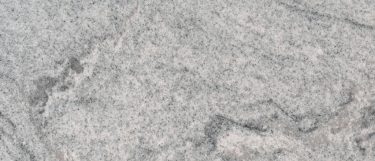 a silver cloud granite countertop surface that features swirling pattern that blends white, gray, silver, and black tones