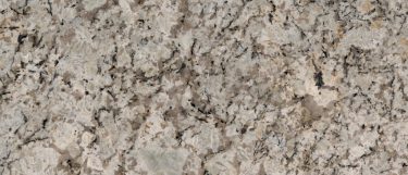 a persa cream granite countertop surface that has gold flecks and veining pattern over the soft white background base