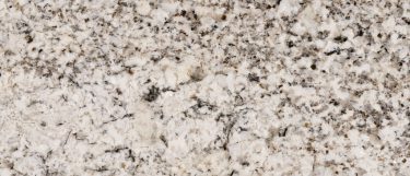 an oyster white granite countertop surface that has gray and black veining pattern over the warm white background