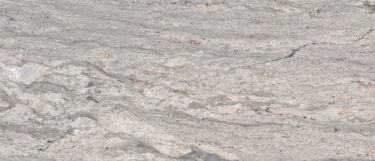 a New River White granite countertop that features a white colored surface with gray swirling vein pattern over the cool white background