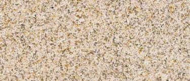 a New Giallo Fantasia granite countertop surface that features gold, gray, and brown fleck details over the cream background