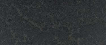 a Nero Mist granite countertop surface that has a dramatic and dark design with flecks and veins in gray over the black background
