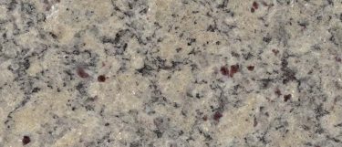 a moon valley countertop surface that has a mizture of white specks, black flecks, and burgundy dots over the soft yellow background