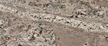 a Lennon granite countertop surface that features a white-gray design with black and brown spots and swirled veining pattern