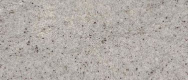 a Himalayan White granite countertop surface that has a cool white background with dark gray speckles throughout