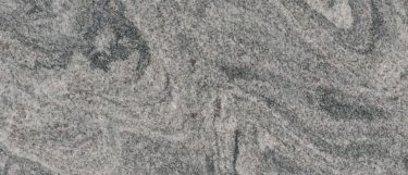 a Gray Mist granite countertop surface that features waves of white and gray hues with flecks details in black
