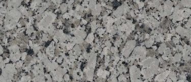 a Gran Valle granite countertop surface that features gray and black specks throughout the light gray background