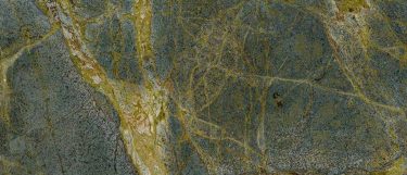 a Golden Lightning granite countertop surface that features gold and brown veins over the green base