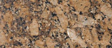 a Giallo Fiorito granite countertop surface that has a golden brown and black pattern