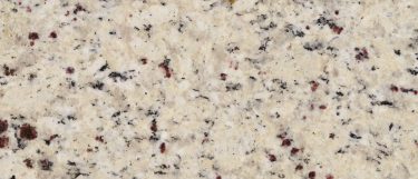 a Giallo Fiesta granite countertop surface that features black and gray specks over the light brown background