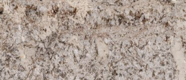 a Ganache granite countertop surface that features gray and white veins with dark charcoal flecks