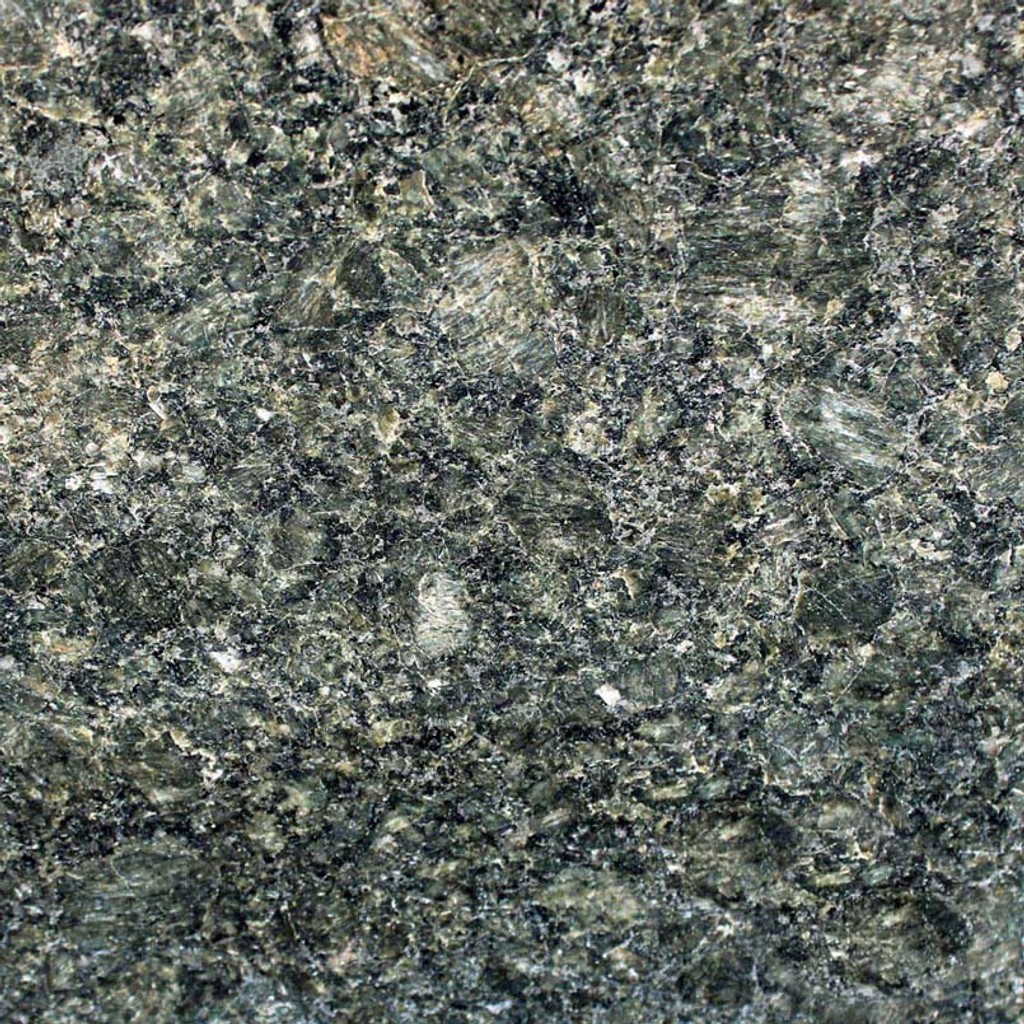 an Emerald Green granite countertop surface that features shades of greens, browns, white, and gold