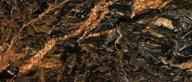 a Desert Dream granite countertop surface that features black, cream, gray, and gold design in a swirling pattern