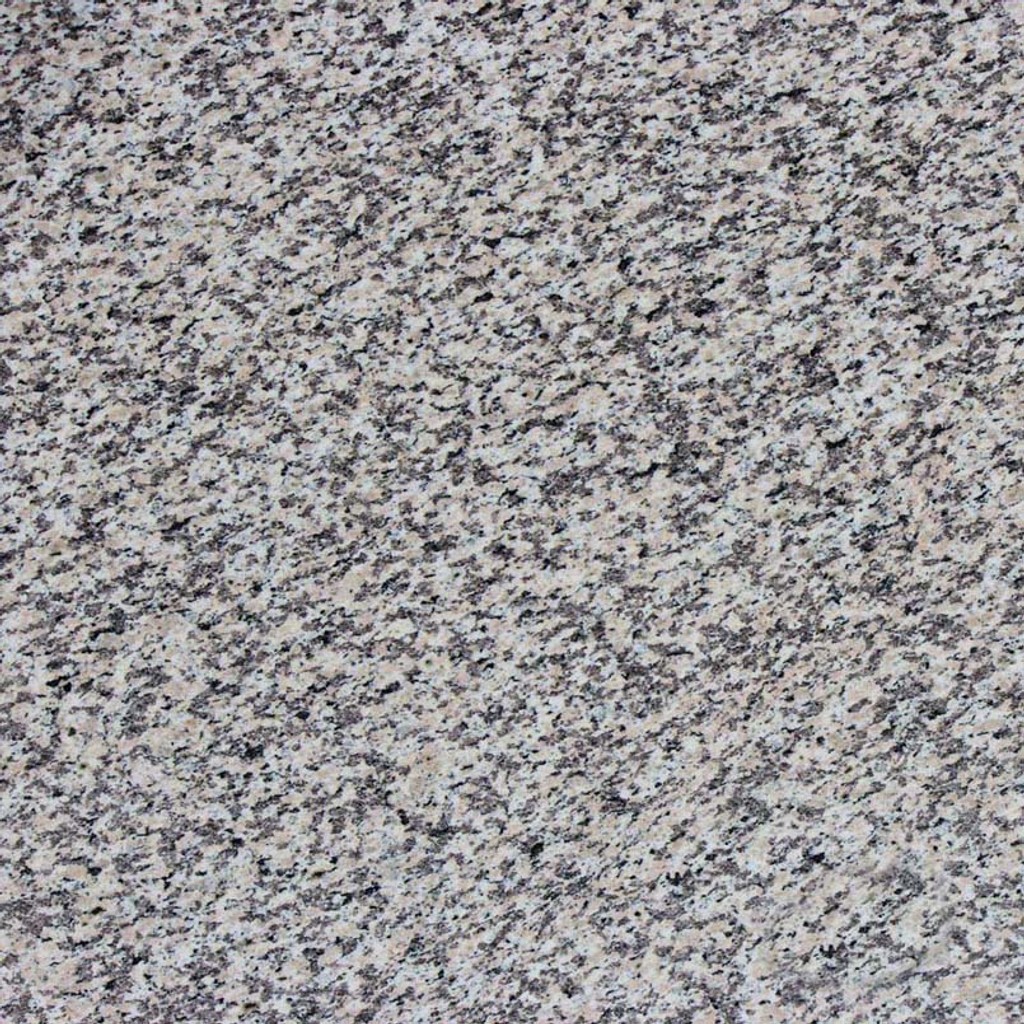 a Crema Perla granite countertop surface that combines colors of gray, cream, white, and black