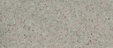 a Colonial Ice granite countertop surface that has burgundy specks and subtle veining in red and gray over the cool white background