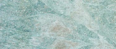 a Caribbean Green granite countertop surface that features light green and beige colors
