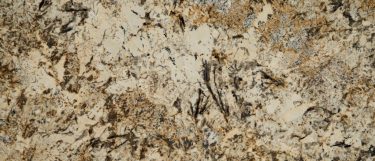 a Caravelas Gold granite countertop surface that features swirls of soft cream with warm browns and cool gray details