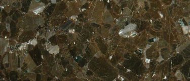 a Brown Antique granite countertop surface that has a chocolate color with blue and platinum colored clustering