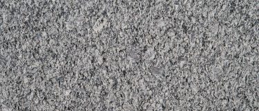 a Blue Ice granite countertop surface that features icy blue colors with specks and flecks in gray, white, and blue