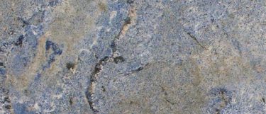 a Blue Bahia granite countertop surface that features shades of blues with grain and vein details in gray and white