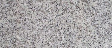 a Blanco Taupe countertop surface that features white and gray colors with black specks detail