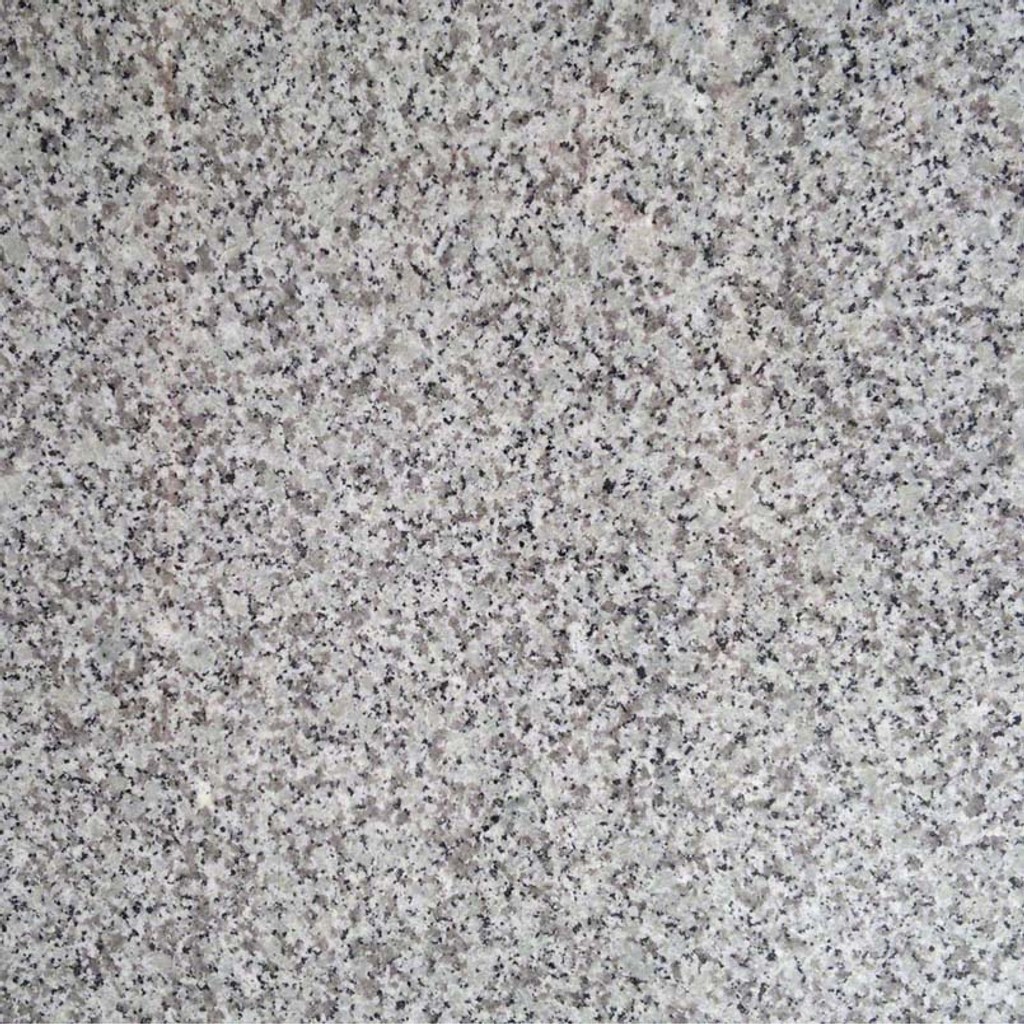 a Blanco Taupe countertop surface that features white and gray colors with black specks detail