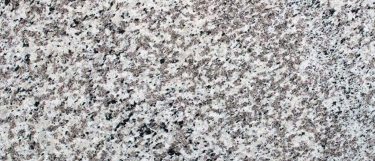 a Blanco Perla countertop surface that features black and cream specks over the pearl white background