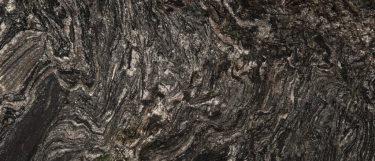 a Black Forest granite countertop surface that has swirls of gray with gray veining details throughout