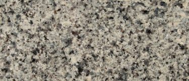 an Azul Platino granite countertop surface that has a light gray color with black and gray specks