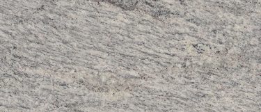 an Arctic Valley granite countertop surface that features sprinkles of gray and black speckles over the white background