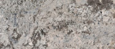an Antico Cream granite countertop surface that features gold and brown flecks with shimmer over the warm white background