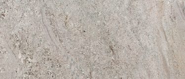 an Andino White granite countertop surface taht features white and gray colors with accents of beige and charcoal details