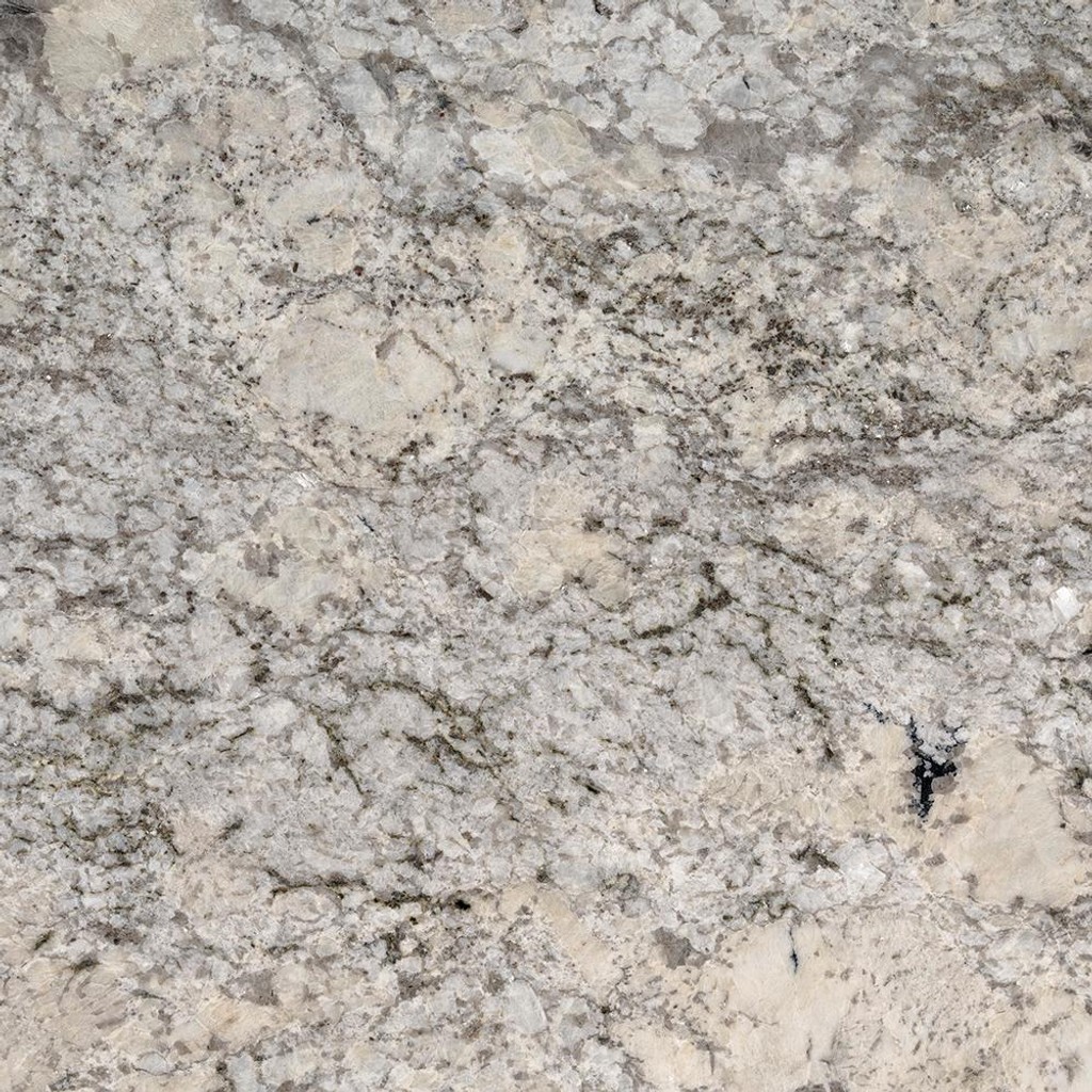 an Alpine Valley granite countertop surface that features beige, black, and charcoal accents over the warm white background
