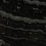 an Agatha Black granite countertop surface that features light gray and white wavy veins over the dark black background