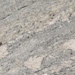 an African Rainbow granite countertop surface that features multi-colored veining in beige, light gray, russet, and blue