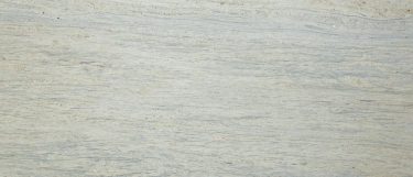 a white river granite countertop surface with burgundy specks and gray veining on the warm white background