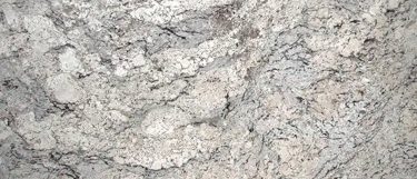 a white ice granite countertop surface with a cool white base with flecks of gray, white, and black