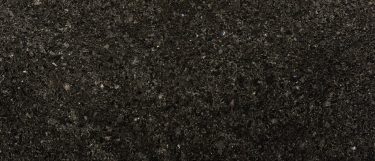 a volga blue granite countertop surface that features a midnight blue background with light gray, blue, and white speckles throughout