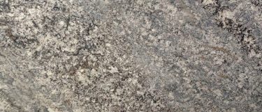 a sterling granite countertop surface with granular pattern of beige, brown, black, and gray