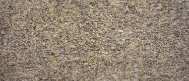 a santa cecilia granite countertop surface that blends warm colors of yellow, gold, black, and burgundy