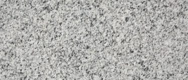 a palladium white granite countertop surface that has gray details over the white base
