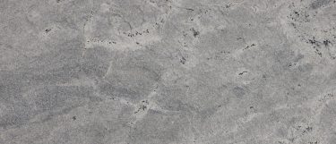 a Hymalaya White granite countertop surface that has dark gray speckles throughout the cool white background