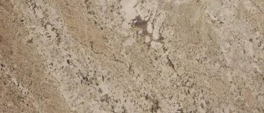 an Exodus White granite countertop surface that features granular design and veining over the creamy white background
