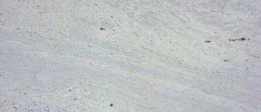 a Bianco Romano granite countertop surface that features gray and tan veining and specks over the white background
