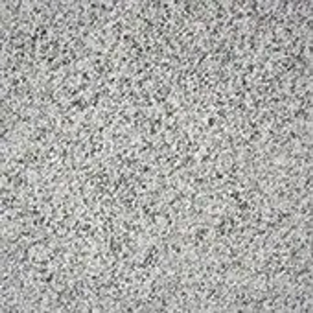 an Ashen White granite countertop surface that features gray specks over white background