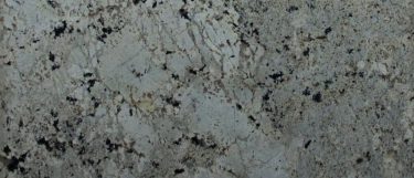 a white paradise granite countertop surface black and gray specks and wave pattern in beige, gray, and silver