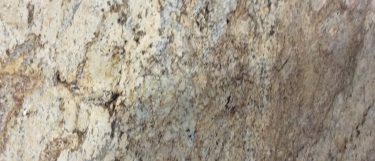 a sienna beige granite countertop that blends various shades of brown, cream, and gray over its surface