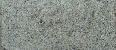 a New Venetian Gold granite countertop that features veining pattern of red, grays, and brown over its golden beige surface
